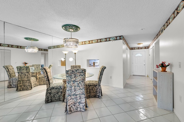 7 Stratford Dr Unit C, Boynton Beach, FL 33436 - dining space with tile patterned floors, a textured ceiling, and baseboards