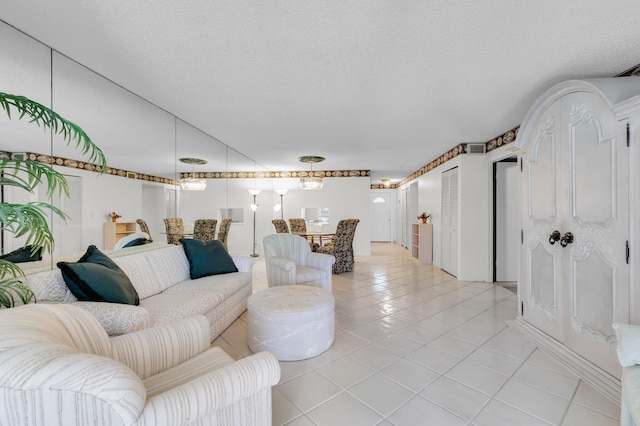 7 Stratford Dr Unit C, Boynton Beach, FL 33436 - living room with light tile patterned floors and a textured ceiling