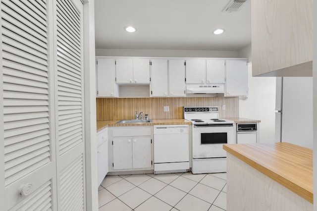 7 Stratford Dr Unit C, Boynton Beach, FL 33436 - kitchen featuring white appliances, under cabinet range hood, light countertops, a sink, and light tile patterned floors