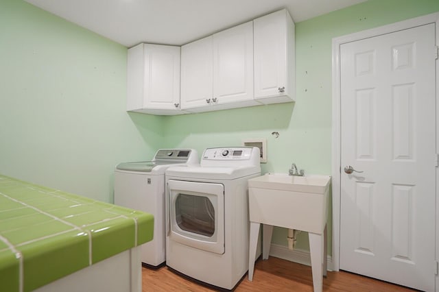 4040 Gem Lake Dr, Glen Ridge, FL 33406 - washroom featuring cabinet space, independent washer and dryer, and light wood finished floors