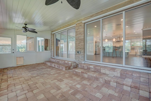 4040 Gem Lake Dr, Glen Ridge, FL 33406 - unfurnished sunroom with a ceiling fan, entry steps, and healthy amount of natural light