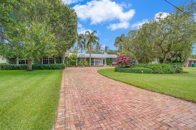 4040 Gem Lake Dr, Glen Ridge, FL 33406 - view of front of home featuring a front lawn, decorative driveway, and metal roof