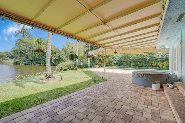 4040 Gem Lake Dr, Glen Ridge, FL 33406 - view of patio / terrace featuring a hot tub, a water view, and view of wooded area