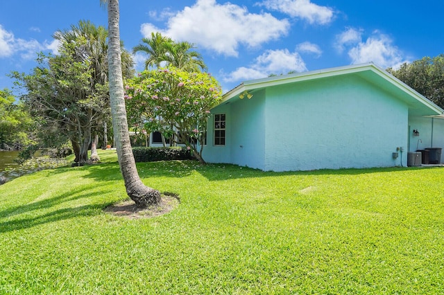 4040 Gem Lake Dr, Glen Ridge, FL 33406 - view of side of property with stucco siding, a yard, and cooling unit