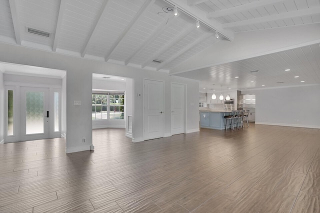 4040 Gem Lake Dr, Glen Ridge, FL 33406 - unfurnished living room featuring rail lighting, wood finished floors, baseboards, and wood ceiling
