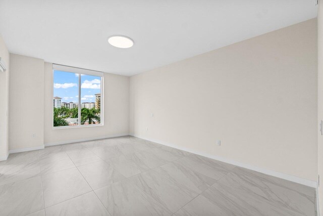 220 SE Mizner Blvd Unit 409, Boca Raton, FL 33432 - empty room with baseboards