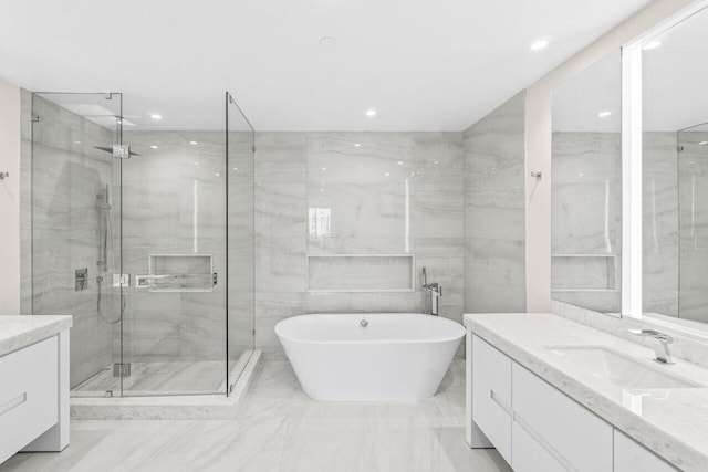 220 SE Mizner Blvd Unit 409, Boca Raton, FL 33432 - full bathroom featuring vanity, marble tiled floors, a shower stall, a soaking tub, and recessed lighting