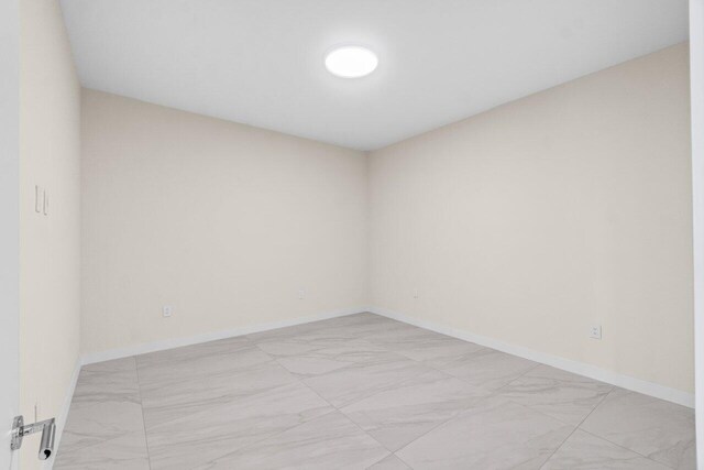 220 SE Mizner Blvd Unit 409, Boca Raton, FL 33432 - empty room with light marble finish flooring and baseboards