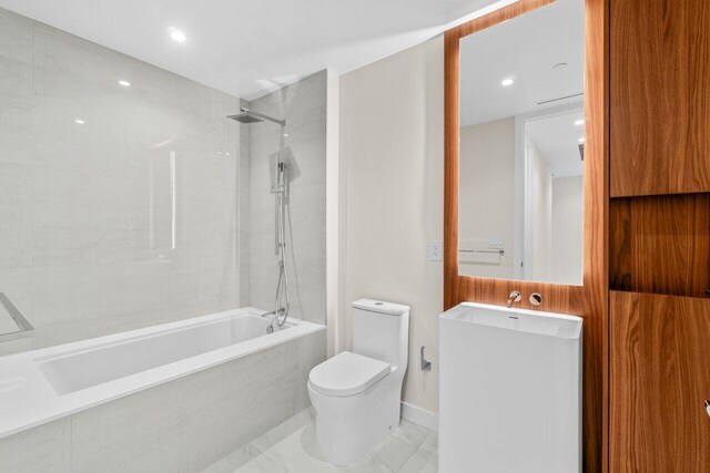 220 SE Mizner Blvd Unit 409, Boca Raton, FL 33432 - bathroom with toilet, tiled shower / bath combo, vanity, and recessed lighting