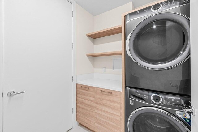 220 SE Mizner Blvd Unit 409, Boca Raton, FL 33432 - washroom featuring stacked washer / dryer