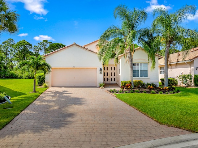 296 NW Toscane Trl, Port Saint Lucie, FL 34986 - mediterranean / spanish-style home featuring stucco siding, an attached garage, a front yard, and driveway