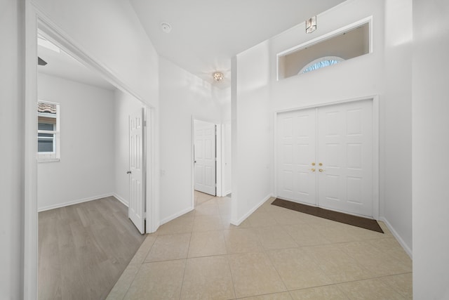 296 NW Toscane Trl, Port Saint Lucie, FL 34986 - entrance foyer with a high ceiling, healthy amount of natural light, and baseboards