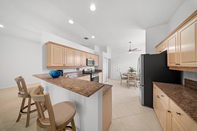 296 NW Toscane Trl, Port Saint Lucie, FL 34986 - kitchen featuring stainless steel appliances, light brown cabinetry, a kitchen breakfast bar, a ceiling fan, and recessed lighting