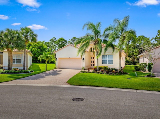 296 NW Toscane Trl, Port Saint Lucie, FL 34986 - mediterranean / spanish house with an attached garage, a front yard, driveway, and stucco siding