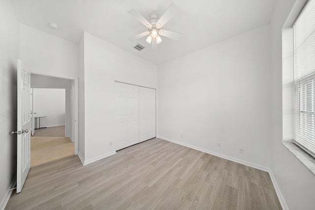 296 NW Toscane Trl, Port Saint Lucie, FL 34986 - unfurnished bedroom featuring light wood-style flooring, baseboards, a closet, and a ceiling fan