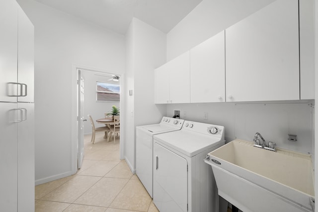 296 NW Toscane Trl, Port Saint Lucie, FL 34986 - washroom with cabinet space, washing machine and clothes dryer, baseboards, light tile patterned floors, and a ceiling fan