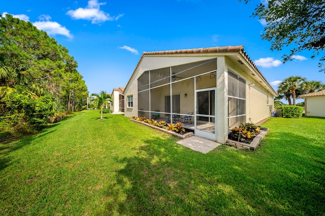 296 NW Toscane Trl, Port Saint Lucie, FL 34986 - back of house with a yard, stucco siding, a sunroom, and a tiled roof