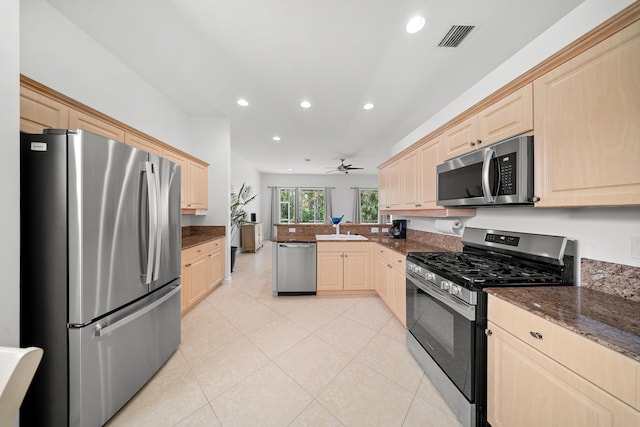 296 NW Toscane Trl, Port Saint Lucie, FL 34986 - kitchen with stainless steel appliances, light brown cabinets, a peninsula, recessed lighting, and a ceiling fan