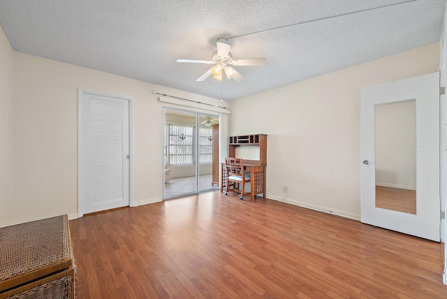 222 Wellington Unit G, West Palm Beach, FL 33417 - spare room with a ceiling fan, wood finished floors, baseboards, and a textured ceiling