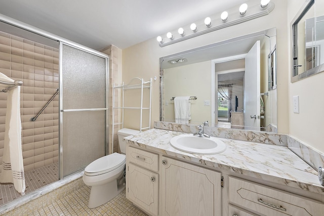 222 Wellington Unit G, West Palm Beach, FL 33417 - full bathroom with a stall shower, vanity, toilet, and tile patterned flooring