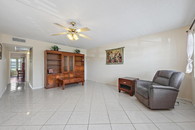 222 Wellington Unit G, West Palm Beach, FL 33417 - sitting room with ceiling fan, lofted ceiling, a textured ceiling, and light tile patterned floors