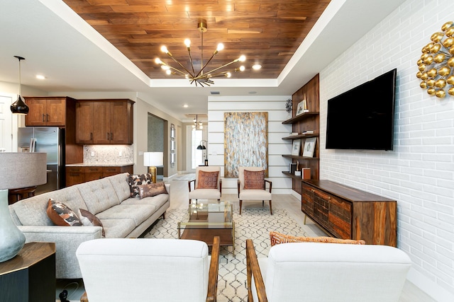 17155 SW Ambrose Way, Port Saint Lucie, FL 34986 - living room with a raised ceiling, a chandelier, wooden ceiling, light wood-style flooring, and baseboards