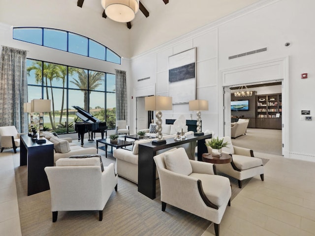 17155 SW Ambrose Way, Port Saint Lucie, FL 34986 - living room with a towering ceiling, a ceiling fan, and a chandelier