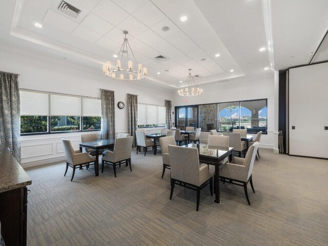 17155 SW Ambrose Way, Port Saint Lucie, FL 34986 - carpeted dining area with a raised ceiling, a chandelier, recessed lighting, and ornamental molding