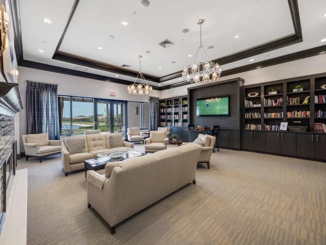 17155 SW Ambrose Way, Port Saint Lucie, FL 34986 - living room featuring a tray ceiling, a chandelier, carpet flooring, and ornamental molding