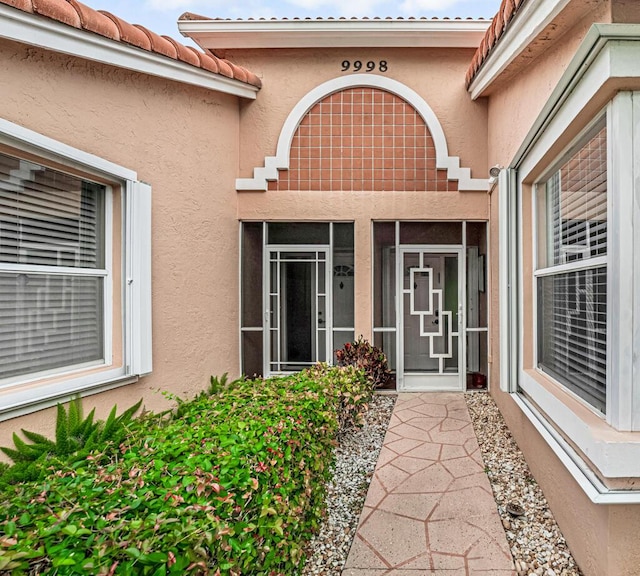 9998 Seacrest Cir Unit C, Boynton Beach, FL 33437 - entrance to property with stucco siding and a tiled roof