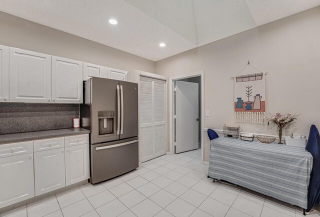 9998 Seacrest Cir Unit C, Boynton Beach, FL 33437 - kitchen with stainless steel fridge with ice dispenser, white cabinets, dark countertops, light tile patterned floors, and recessed lighting