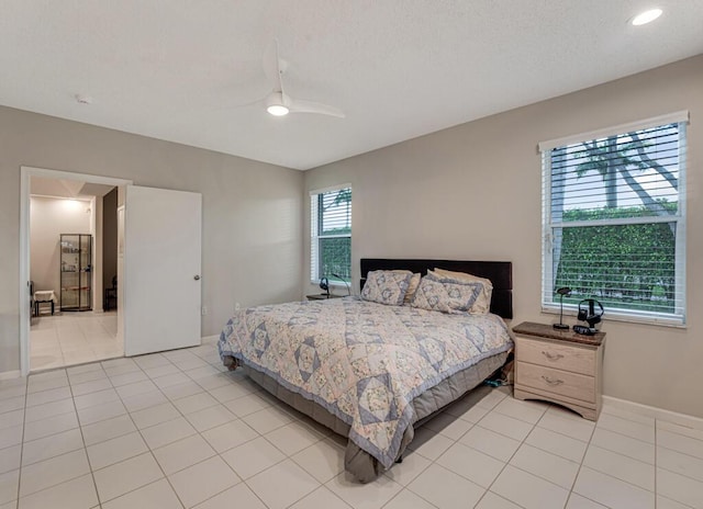 9998 Seacrest Cir Unit C, Boynton Beach, FL 33437 - bedroom with light tile patterned flooring, a ceiling fan, a textured ceiling, and baseboards