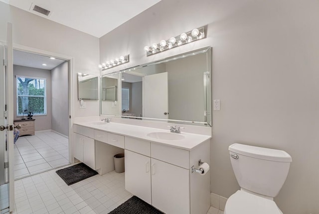 9998 Seacrest Cir Unit C, Boynton Beach, FL 33437 - bathroom with double vanity, toilet, tile patterned floors, and baseboards