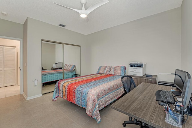 9998 Seacrest Cir Unit C, Boynton Beach, FL 33437 - bedroom featuring a closet, a desk, ceiling fan, a textured ceiling, and light tile patterned floors