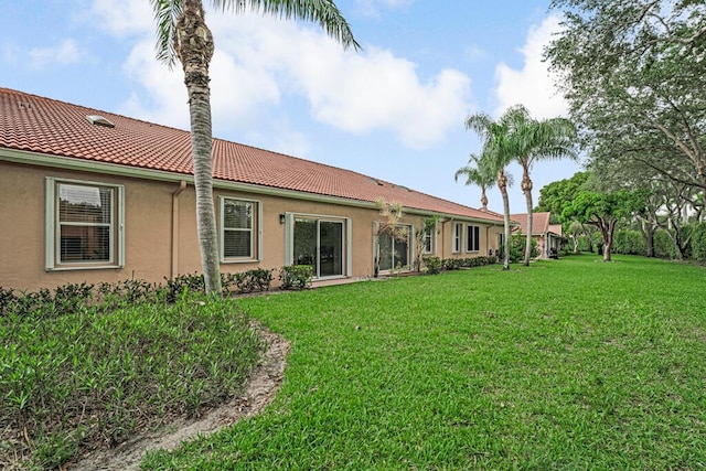 9998 Seacrest Cir Unit C, Boynton Beach, FL 33437 - rear view of property with stucco siding, a yard, and a tile roof