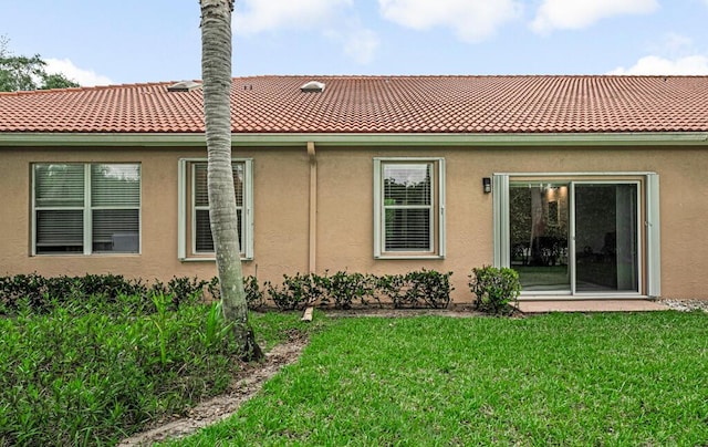9998 Seacrest Cir Unit C, Boynton Beach, FL 33437 - rear view of property with a yard, stucco siding, and a tile roof