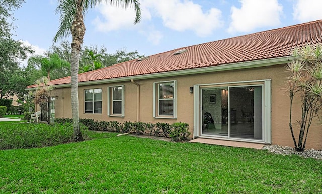 9998 Seacrest Cir Unit C, Boynton Beach, FL 33437 - rear view of property featuring a tiled roof, stucco siding, and a lawn