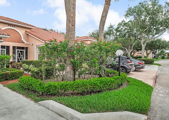 9998 Seacrest Cir Unit C, Boynton Beach, FL 33437 - view of side of property featuring a tile roof and stucco siding