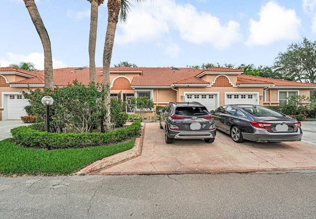 9998 Seacrest Cir Unit C, Boynton Beach, FL 33437 - view of front of home featuring a tile roof, stucco siding, and concrete driveway