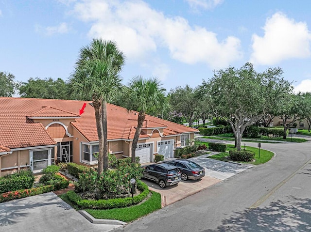 9998 Seacrest Cir Unit C, Boynton Beach, FL 33437 - view of property with driveway and a garage