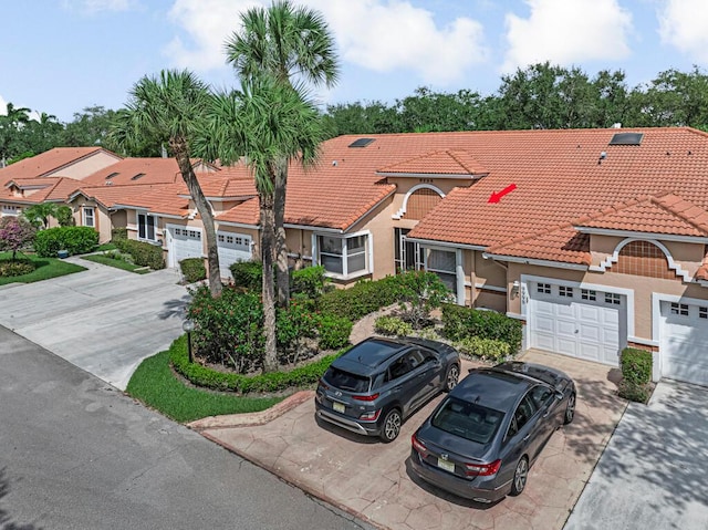9998 Seacrest Cir Unit C, Boynton Beach, FL 33437 - view of front of house featuring stucco siding, concrete driveway, a tile roof, and a garage