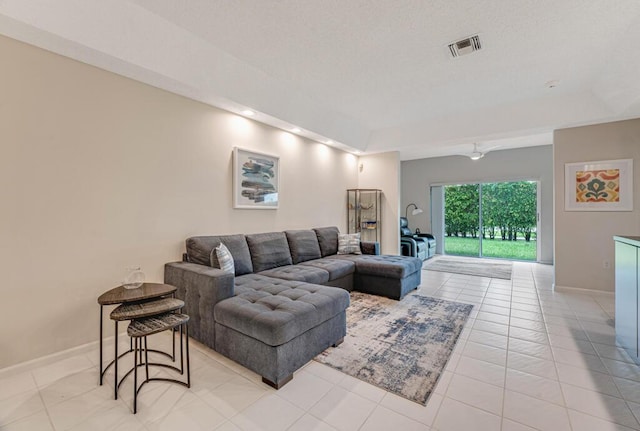 9998 Seacrest Cir Unit C, Boynton Beach, FL 33437 - living room featuring a tray ceiling, baseboards, and light tile patterned floors