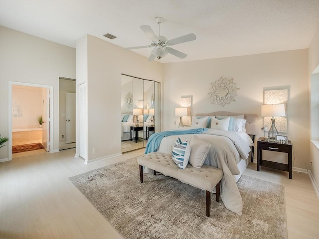 8520 Lake Cypress Rd, Lake Worth, FL 33467 - bedroom featuring light wood-style floors, baseboards, ceiling fan, and connected bathroom