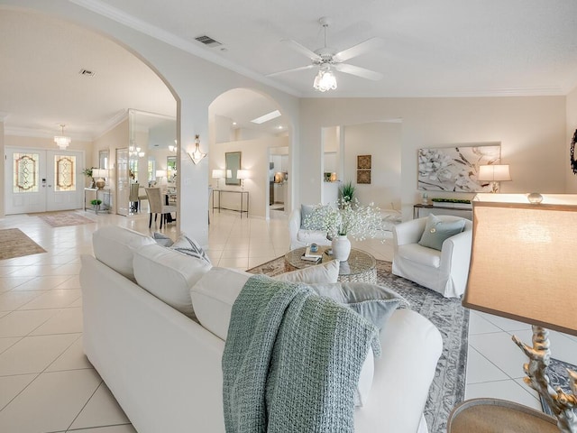 8520 Lake Cypress Rd, Lake Worth, FL 33467 - living room featuring arched walkways, light tile patterned floors, ornamental molding, ceiling fan, and baseboards