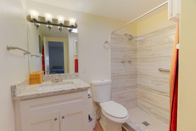 3000 Lake Osborne Dr Unit 103, Lake Worth Beach, FL 33461 - bathroom with a tile shower, vanity, toilet, and connected bathroom