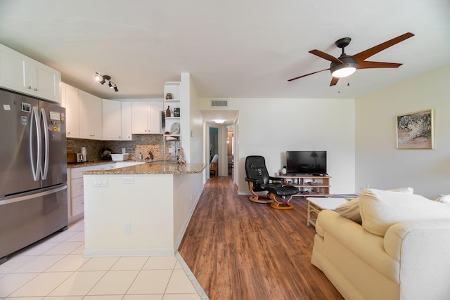 3000 Lake Osborne Dr Unit 103, Lake Worth Beach, FL 33461 - kitchen with freestanding refrigerator, open floor plan, open shelves, a peninsula, and a ceiling fan