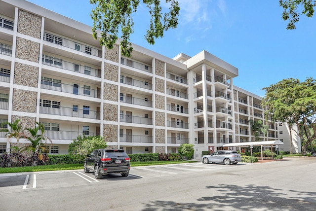 2751 N Palm Aire Dr Unit 304, Pompano Beach, FL 33069 - view of apartment building / complex featuring uncovered parking