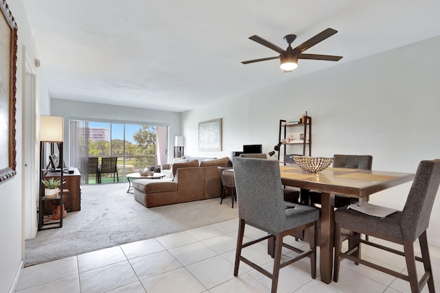 2751 N Palm Aire Dr Unit 304, Pompano Beach, FL 33069 - dining area featuring light carpet, ceiling fan, and light tile patterned floors