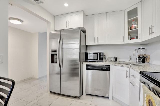 2751 N Palm Aire Dr Unit 304, Pompano Beach, FL 33069 - kitchen featuring stainless steel appliances, a sink, light stone countertops, white cabinets, and recessed lighting