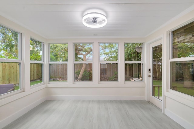 305 Vanderbilt Dr, Lake Worth Beach, FL 33460 - unfurnished sunroom with healthy amount of natural light, wood finished floors, crown molding, and baseboards